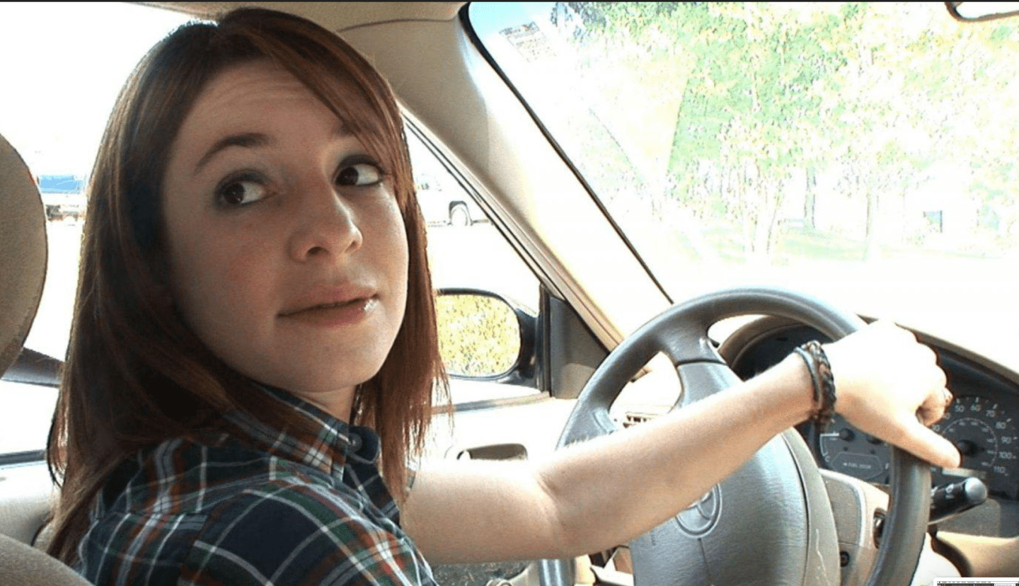 woman backing up car